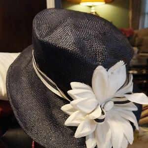 Elegant Navy Hat with White Floral Accent.